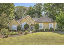 Charming single-story home with a manicured lawn, mature trees, and a welcoming front entrance, perfect for suburban living at 184 Glenn Eagles Way, Hiram, GA 30141