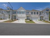 Charming townhome with white siding, a two-car garage, and a well-manicured lawn at 2139 Kirkham Way, Kennesaw, GA 30152