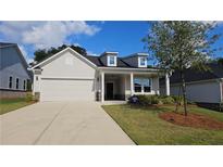 Charming single-Gathering home featuring a two-car garage, dormer windows, and well-maintained landscaping at 621 Pineberry Ct, Grayson, GA 30017