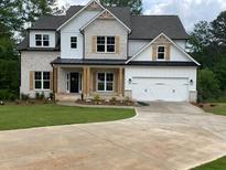 Beautiful two-story home featuring a brick and white exterior and a spacious two car garage at 2021 Shallowford Rd, Marietta, GA 30066