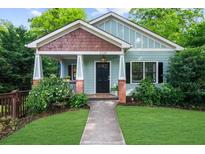 Charming craftsman home boasts a tidy front lawn, quaint porch, and stylish architectural details at 2324 Oakview Ne Rd, Atlanta, GA 30317