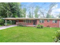 Charming single-story brick home featuring a carport and lush green lawn at 3179 Dogwood Dr, Atlanta, GA 30344