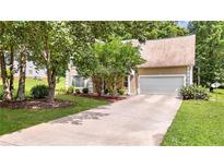 Charming home featuring manicured lawn, two-car garage, and mature trees providing ample shade at 3358 North Ct, Ellenwood, GA 30294