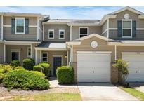 Charming townhome featuring a one-car garage and well-maintained landscaping for added curb appeal at 554 Rendevous Rd, Acworth, GA 30102