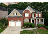 Beautiful two-story brick home with a well-manicured lawn and a two-car garage at 3310 Vista Creek Dr, Dacula, GA 30019