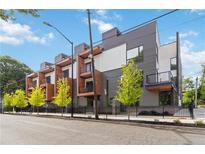Modern townhomes with stylish gray and white exteriors, accented by wood trim and private balconies at 367 Parkway Ne Dr # 9, Atlanta, GA 30312