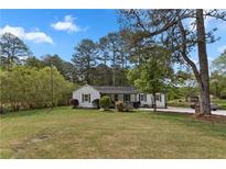 Charming single-story home featuring a well-maintained lawn and inviting curb appeal in a quiet neighborhood at 2014 Fence Rd, Dacula, GA 30019