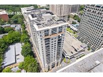 Aerial view of a luxury high-rise condo building with balconies and surrounding cityscape at 3040 Peachtree Nw Rd # 1803, Atlanta, GA 30305