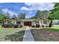 Charming single-story home with stone accents and a well-manicured lawn and walkway at 3467 Clubland Dr, Marietta, GA 30068
