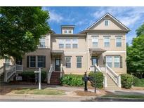 Inviting townhome with charming front porch and well-maintained landscaping in a desirable neighborhood at 4400 Village Field Pl, Suwanee, GA 30024