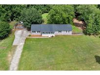 An aerial view of a charming single-story home with a spacious lawn and mature trees at 1810 King Mill Rd, Mcdonough, GA 30252