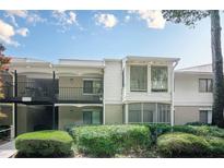 Charming condo with white siding, a balcony, and lush landscaping at 2015 Wingate Way, Atlanta, GA 30350