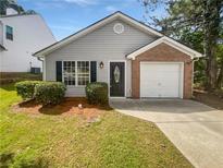 Charming single-story home with gray siding, brick accent, and well-maintained front lawn at 6795 Browns Mill Walk, Lithonia, GA 30038