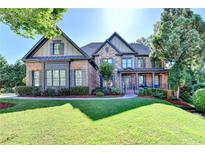 Beautiful two-story home with manicured lawn, stone accents, and a welcoming front porch at 2996 Walkin Horse Trl, Buford, GA 30519