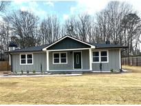 Charming single-story home with a gray exterior, white trim, and a well-manicured front lawn at 487 Eastside Dr, Dacula, GA 30019