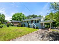 Charming single Gathering home boasts beautiful landscaping and a covered parking area at 1985 Thomasville Se Dr, Atlanta, GA 30315