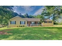 Charming single-story home featuring a well-manicured lawn, inviting front porch, and classic curb appeal at 200 Compton Ct, Mcdonough, GA 30252