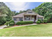 Charming single-story home with a manicured lawn and mature landscaping creating an inviting curb appeal at 408 Gray Fox Dr, Canton, GA 30114