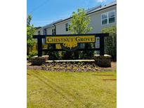 Community sign for Chestnut Grove featuring manicured landscaping, located in quiet residential area at 5004 Elowen Ln, Douglasville, GA 30135
