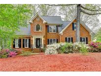 Charming brick home with a manicured lawn, beautiful landscaping, and a welcoming entrance at 134 Waterloch Ct, Lawrenceville, GA 30043