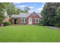 Charming brick home with a lush green lawn and beautiful landscaping at 655 E Pelham Ne Rd, Atlanta, GA 30324