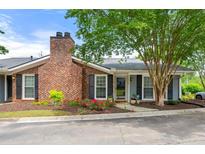 Charming exterior view of a single-story home with a brick chimney and beautifully landscaped front yard at 1141 Moorestown Cir, Decatur, GA 30033