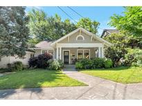 Charming bungalow with mature landscaping, inviting front porch and traditional architectural details at 1231 Mansfield Ne Ave, Atlanta, GA 30307