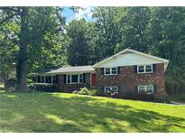 Charming two-story brick home featuring a well-manicured front yard and a classic architectural style at 5669 Hillcrest Dr, Acworth, GA 30102