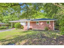 Charming brick home with a well-maintained lawn and mature trees, offering a serene curb appeal at 7577 Haley Dr, Jonesboro, GA 30236