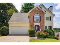 Charming two-story home with brick facade, manicured landscaping, and attached two-car garage at 4305 Chesapeake Trce, Acworth, GA 30101