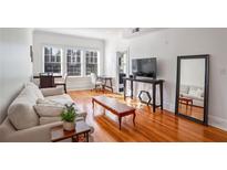 Bright living room featuring hardwood floors, large windows, and stylish furniture at 690 Piedmont Ne Ave # 17, Atlanta, GA 30308