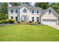 Charming two-story home with landscaped yard and a well manicured lawn at 125 Sandridge Ct, Alpharetta, GA 30022