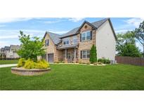 Charming two-story home with a well-manicured lawn and a two car garage at 321 Shannon Ct, Mcdonough, GA 30252