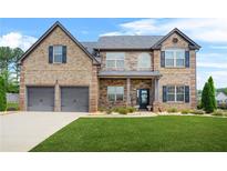 Beautiful two-story brick home with a manicured lawn and a two-car garage at 321 Shannon Ct, Mcdonough, GA 30252