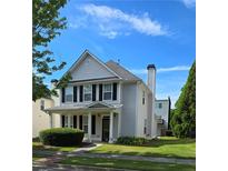Charming two-story home with gray siding, black shutters, a chimney, and a well-manicured lawn on a sunny day at 4677 Liberty Square Dr, Acworth, GA 30101