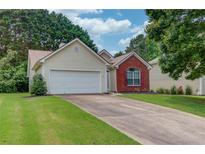 Charming single-Gathering home with a two-car garage and well-maintained front lawn at 965 Under Ct, Sugar Hill, GA 30518
