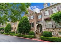 Charming brick townhome with manicured landscaping, stone accents, and inviting curb appeal at 2313 Saint Davids Nw Sq # 12, Kennesaw, GA 30152