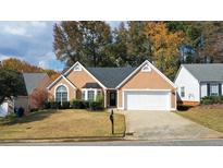 Charming one-story home with a two car garage, well-maintained lawn, and manicured shrubbery at 3625 Ennfield Ln, Duluth, GA 30096