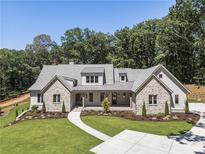 Beautiful stone and siding home with well-manicured lawn and landscaping at 779 Hicks Rd, Canton, GA 30115