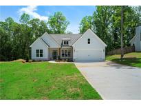 Charming new construction featuring a white board and batten facade and a two-car garage at 270 Harmony Woods Dr, Dallas, GA 30157