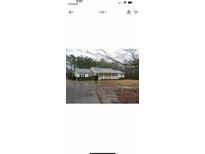 Charming single-story home with inviting front porch and well-maintained landscaping at 4825 Rollins Dr, Powder Springs, GA 30127