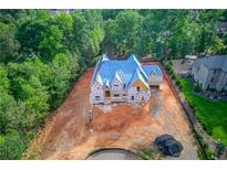Expansive lot featuring a new construction home with advanced roof in a serene wooded neighborhood at 2808 Carson Garrett Ct, Buford, GA 30519