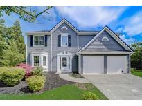 Charming two-story home with a well-manicured lawn, beautiful landscaping, and an attached two-car garage at 870 Underhill Ct, Sugar Hill, GA 30518
