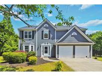 Charming two-story home featuring a well-maintained lawn and a two-car garage at 870 Underhill Ct, Sugar Hill, GA 30518