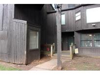 Rustic condo exterior with weathered wood, covered porch, and natural surroundings at 2814 Shellbark Rd, Decatur, GA 30035