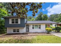 Charming two-story home boasts a white brick foundation and blue siding with a well-maintained lawn at 479 Charter Oak Sw Dr, Atlanta, GA 30331