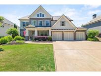 Charming two-story home with a manicured lawn, a three-car garage, and classic American design at 337 Spotted Ridge Cir, Woodstock, GA 30188