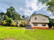 Split-level home featuring a brick facade and landscaped front yard at 792 Oneta Dr, Norcross, GA 30093