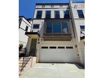 Charming home featuring a brick facade, garage, and multi-level windows for abundant natural light at 1109 Rivard Nw Cir, Atlanta, GA 30318