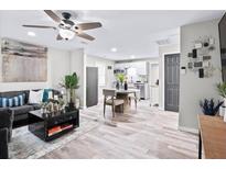 Open-concept living room featuring modern decor, updated flooring, and stainless steel appliances at 246 Aurora Nw Ave, Atlanta, GA 30314